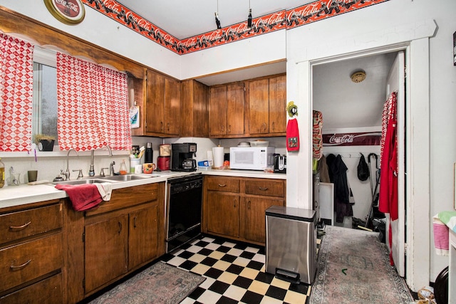 51 Dunning Ave, Battle Creek, MI 49037 - kitchen with dishwasher, white microwave, dark floors, light countertops, and a sink