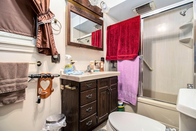 51 Dunning Ave, Battle Creek, MI 49037 - bathroom featuring vanity, enclosed tub / shower combo, and toilet