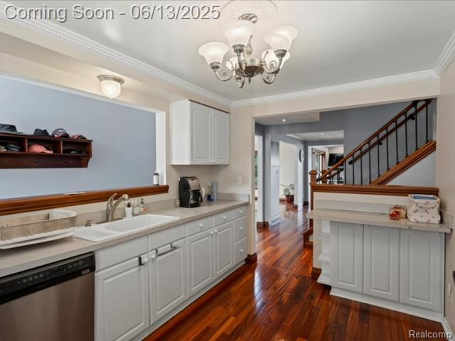 4967 Coshocton Dr, Waterford, MI 48327 - kitchen featuring stainless steel dishwasher, a sink, ornamental molding, a chandelier, and white cabinets