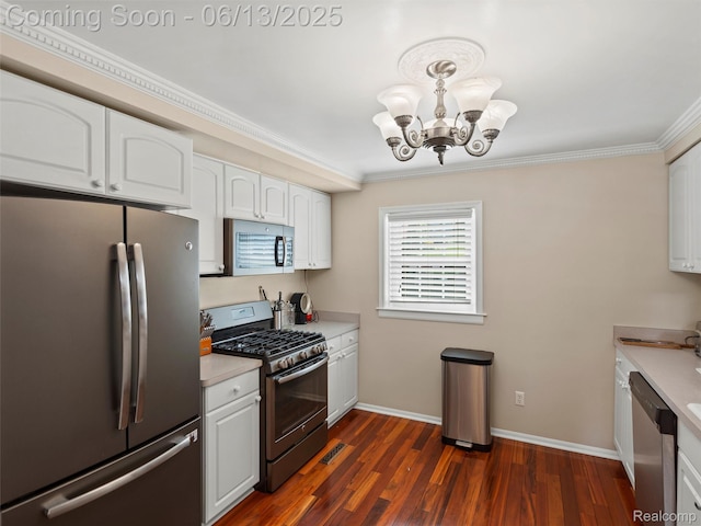 4967 Coshocton Dr, Waterford, MI 48327 - kitchen featuring appliances with stainless steel finishes, a chandelier, ornamental molding, white cabinetry, and light countertops