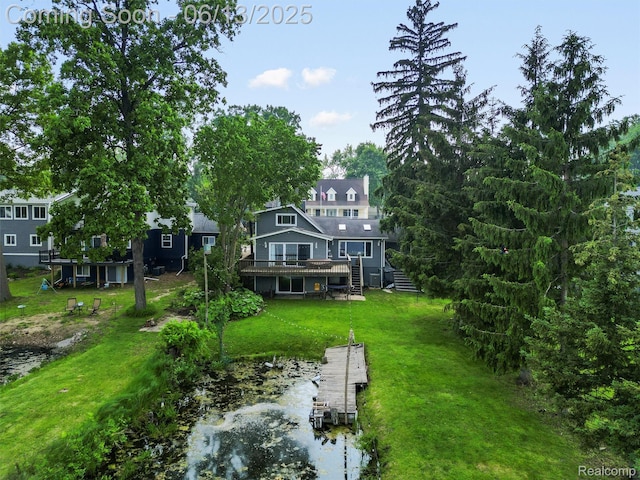 4967 Coshocton Dr, Waterford, MI 48327 - rear view of property with a deck with water view, a lawn, and stairway