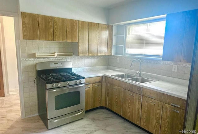 3461 Michael Ave, Warren, MI 48091 - kitchen featuring stainless steel gas stove, light countertops, decorative backsplash, and brown cabinetry