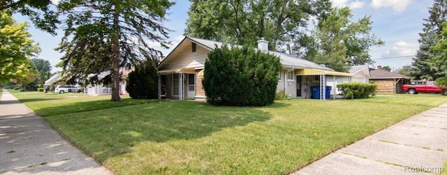 3461 Michael Ave, Warren, MI 48091 - view of front of home with a front lawn and a chimney