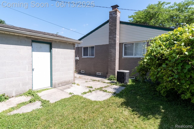 21806 Trombly St, Saint Clair Shores, MI 48080 - back of property featuring a lawn, central AC, a patio, and a chimney