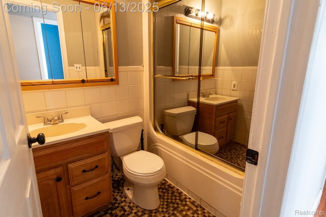 21806 Trombly St, Saint Clair Shores, MI 48080 - bathroom featuring tile walls, toilet, vanity, a wainscoted wall, and bathtub / shower combination