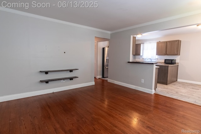 21806 Trombly St, Saint Clair Shores, MI 48080 - unfurnished living room with ornamental molding, wood finished floors, and baseboards