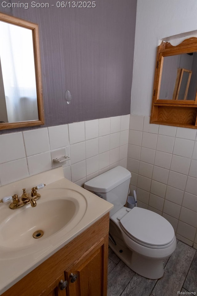 21806 Trombly St, Saint Clair Shores, MI 48080 - half bath featuring tile walls, vanity, toilet, wood finished floors, and wainscoting