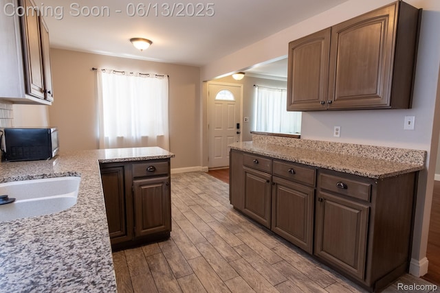 21806 Trombly St, Saint Clair Shores, MI 48080 - kitchen with light wood finished floors, a peninsula, light stone countertops, and baseboards