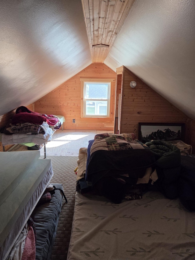 4823 Lakeside Blvd, Hale, MI 48739 - carpeted bedroom featuring wooden walls, lofted ceiling, and a textured ceiling
