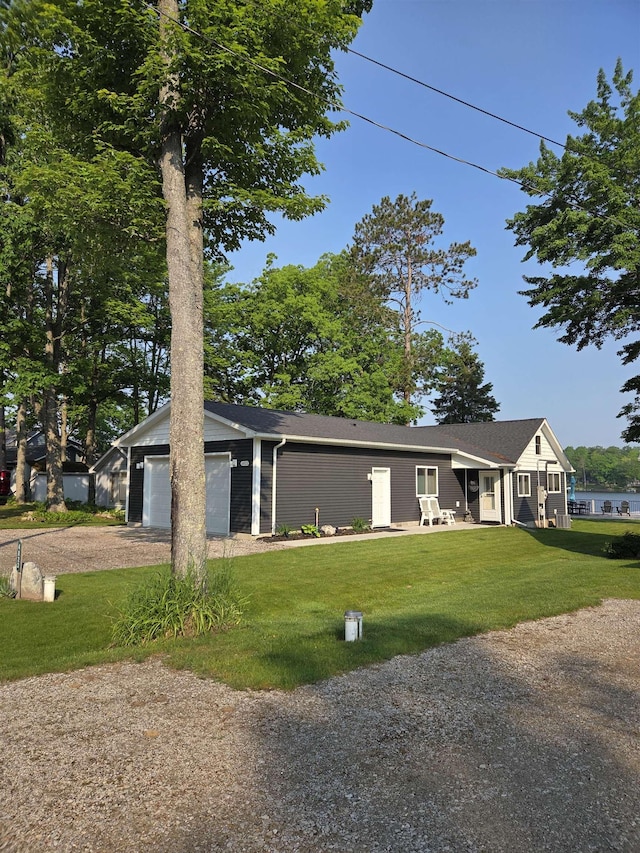 4823 Lakeside Blvd, Hale, MI 48739 - view of front of home featuring driveway, a front lawn, and a garage