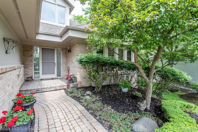 6524 Pleasant Lake Ct, West Bloomfield, MI 48322 - doorway to property featuring brick siding and a shingled roof
