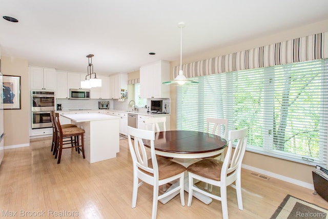 6524 Pleasant Lake Ct, West Bloomfield, MI 48322 - dining space with light wood-style flooring and baseboards