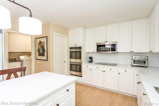 6524 Pleasant Lake Ct, West Bloomfield, MI 48322 - kitchen featuring appliances with stainless steel finishes, independent washer and dryer, light wood-style flooring, tasteful backsplash, and light countertops