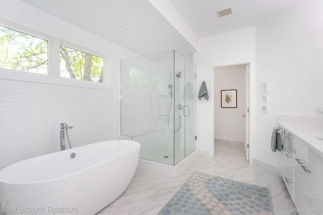 6524 Pleasant Lake Ct, West Bloomfield, MI 48322 - bathroom featuring a shower stall, vanity, a freestanding bath, and marble finish flooring