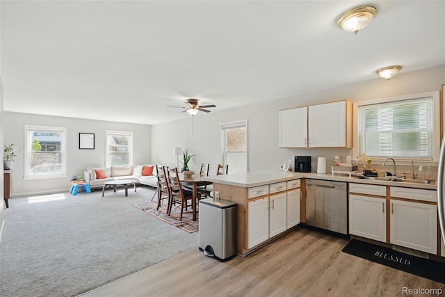 1372 Maryland St, Grosse Pointe, MI 48230 - kitchen with stainless steel dishwasher, open floor plan, a peninsula, a ceiling fan, and light countertops
