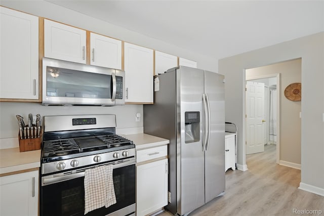 1372 Maryland St, Grosse Pointe, MI 48230 - kitchen featuring appliances with stainless steel finishes, light countertops, light wood finished floors, and white cabinetry