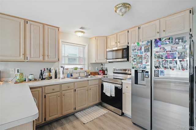 1372 Maryland St, Grosse Pointe, MI 48230 - kitchen with appliances with stainless steel finishes, light countertops, light wood finished floors, and light brown cabinets
