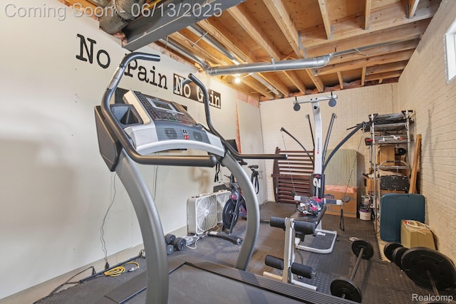 8329 Deer Creek Ct, Grand Blanc, MI 48439 - workout area with brick wall