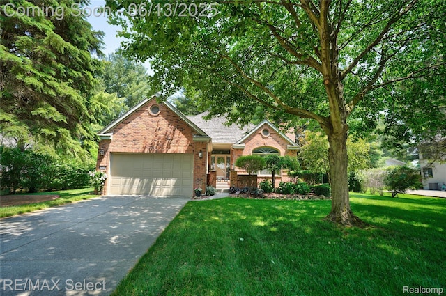 16483 Dawnlight Dr, Fenton, MI 48430 - view of front facade with brick siding, an attached garage, driveway, and a front lawn