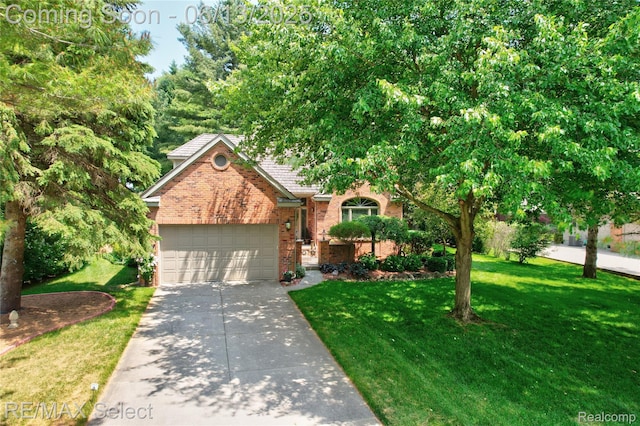 16483 Dawnlight Dr, Fenton, MI 48430 - obstructed view of property with brick siding, a front lawn, an attached garage, and driveway