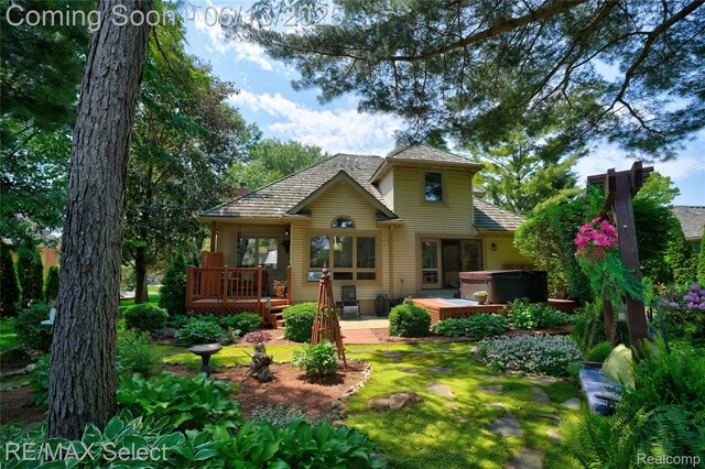 16483 Dawnlight Dr, Fenton, MI 48430 - rear view of house featuring a hot tub and a wooden deck