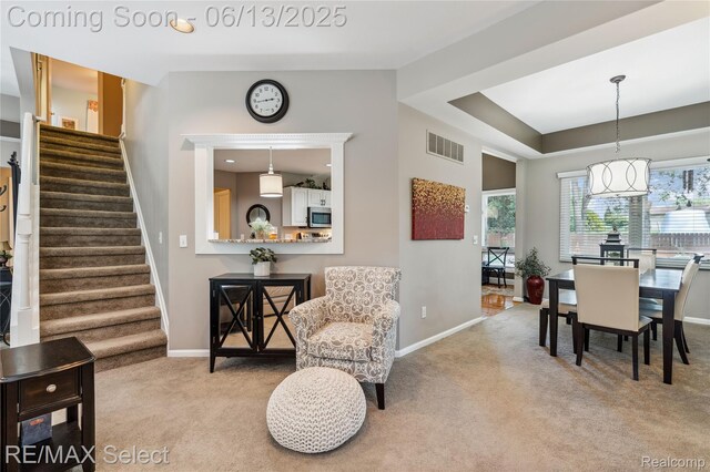 16483 Dawnlight Dr, Fenton, MI 48430 - dining area featuring carpet flooring, stairway, and a chandelier