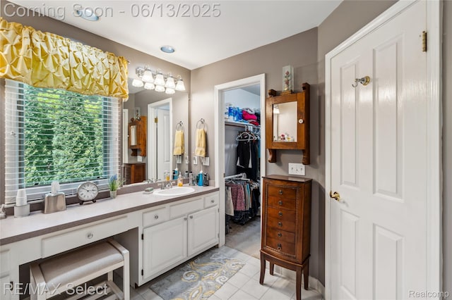 16483 Dawnlight Dr, Fenton, MI 48430 - bathroom featuring vanity, healthy amount of natural light, tile patterned flooring, and a spacious closet