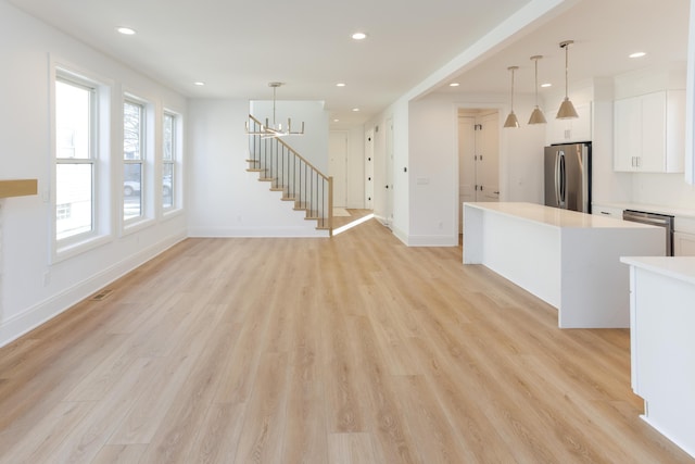 1439 Bennaville Ave, Birmingham, MI 48009 - unfurnished living room with light wood-style flooring, stairs, recessed lighting, and a chandelier