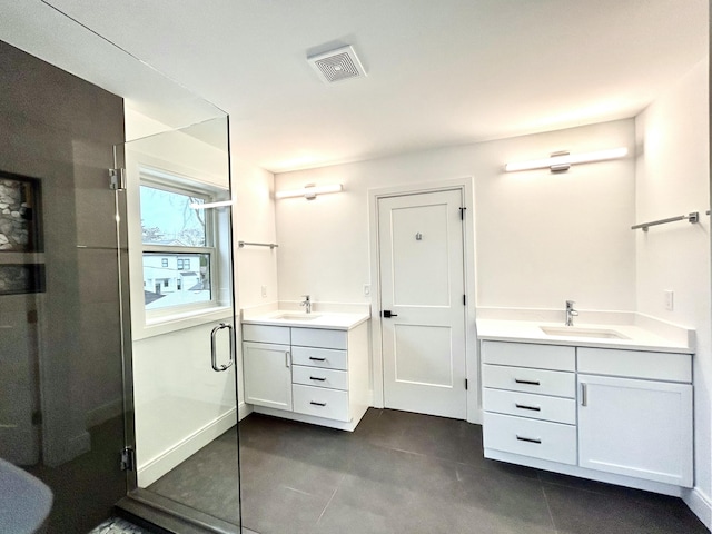 1439 Bennaville Ave, Birmingham, MI 48009 - bathroom with two vanities, a stall shower, and tile patterned flooring