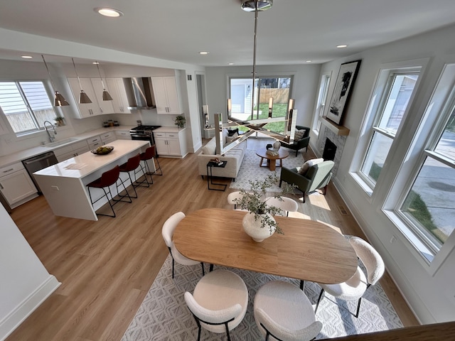 1439 Bennaville Ave, Birmingham, MI 48009 - dining space with plenty of natural light, light wood finished floors, a fireplace, and recessed lighting