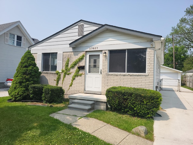 27837 Kaufman St, Roseville, MI 48066 - view of front facade featuring brick siding, a gate, and a detached garage