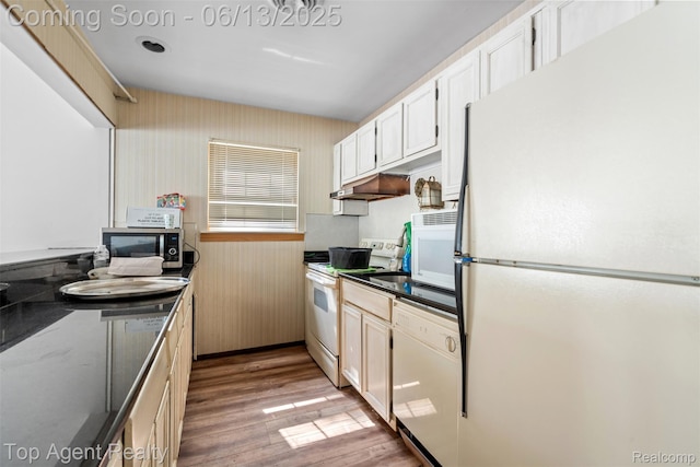 27557 W Echo Vly Unit 153, Farmington Hills, MI 48334 - kitchen featuring white appliances, light wood-style floors, dark countertops, under cabinet range hood, and white cabinets
