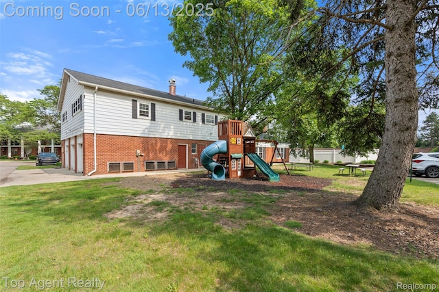 27557 W Echo Vly Unit 153, Farmington Hills, MI 48334 - rear view of house with brick siding, a yard, a garage, a playground, and driveway