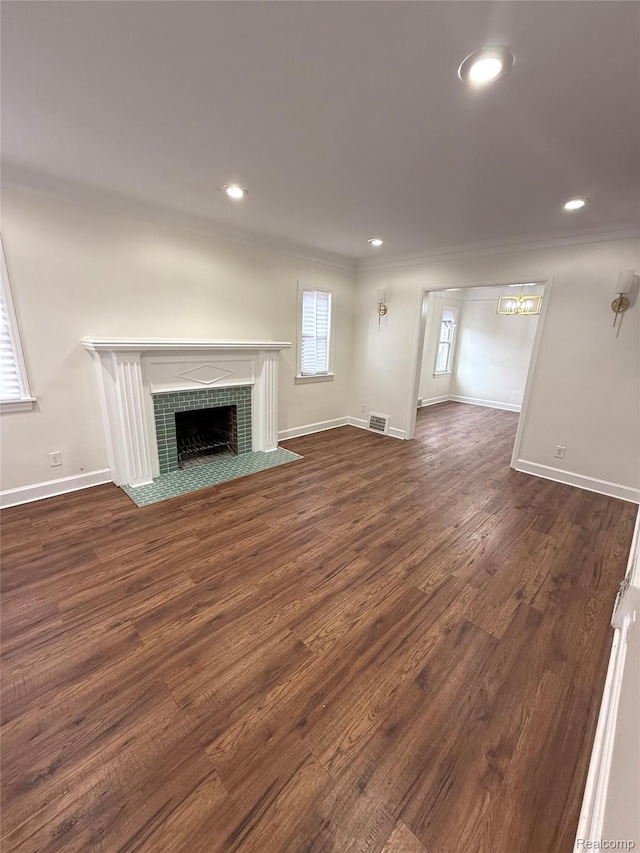 16652 Mendota St, Detroit, MI 48221 - unfurnished living room with dark wood-type flooring, a fireplace, recessed lighting, and crown molding