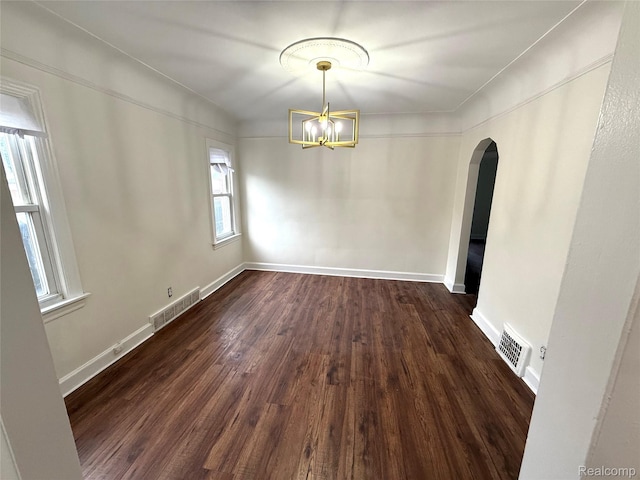 16652 Mendota St, Detroit, MI 48221 - unfurnished dining area featuring arched walkways, dark wood-style floors, and a chandelier