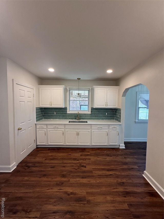 16652 Mendota St, Detroit, MI 48221 - kitchen with light countertops, backsplash, white cabinets, arched walkways, and recessed lighting