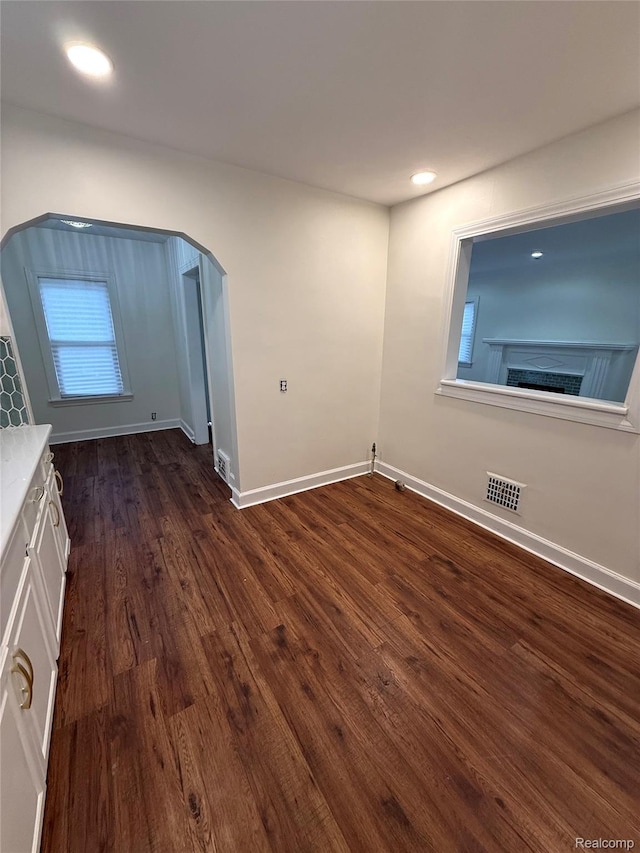 16652 Mendota St, Detroit, MI 48221 - spare room with dark wood-type flooring, arched walkways, and recessed lighting