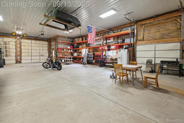 2970 Sand Beach Rd, Bad Axe, MI 48413 - garage featuring a workshop area and white refrigerator with ice dispenser