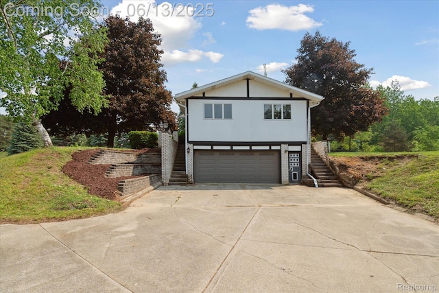 2970 Sand Beach Rd, Bad Axe, MI 48413 - view of front facade with stairway, a garage, and concrete driveway