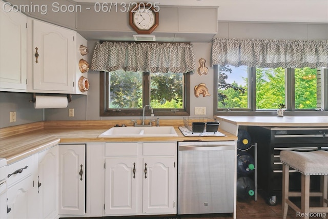 2970 Sand Beach Rd, Bad Axe, MI 48413 - kitchen featuring dishwasher, light countertops, and white cabinets
