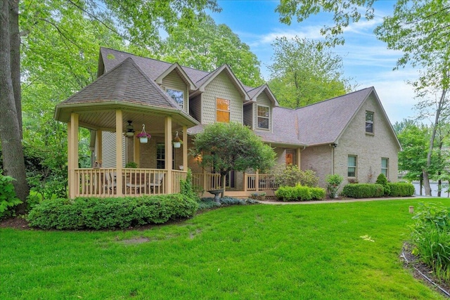 2082 Blackberry Ln, Howell, MI 48855 - view of front facade with a porch, a ceiling fan, and a front lawn