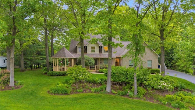2082 Blackberry Ln, Howell, MI 48855 - view of front of home with a front yard and covered porch