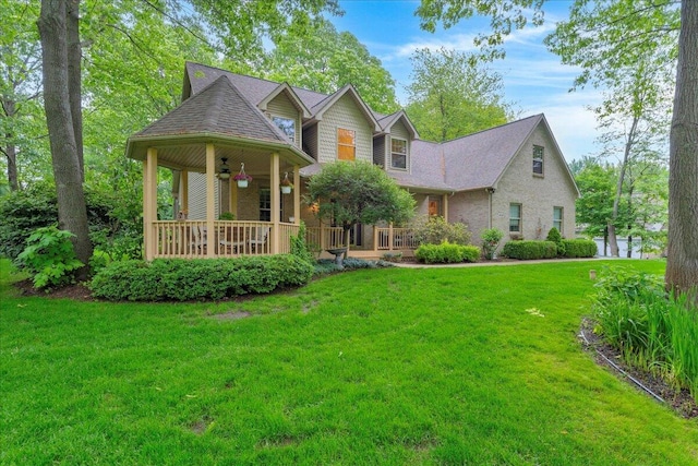 2082 Blackberry Ln, Howell, MI 48855 - view of front of home with ceiling fan, a porch, and a front yard