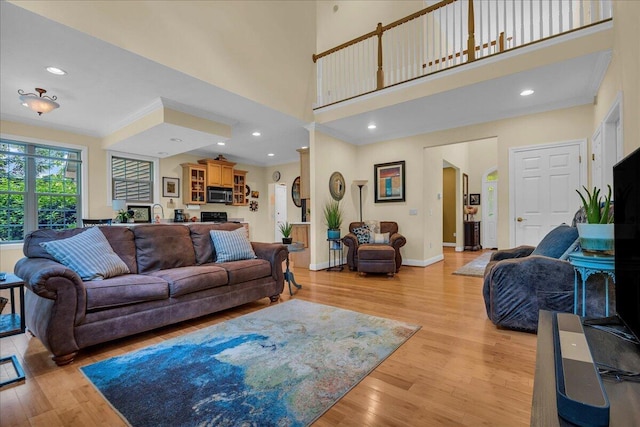 2082 Blackberry Ln, Howell, MI 48855 - living room with crown molding, light wood-style flooring, baseboards, recessed lighting, and a towering ceiling