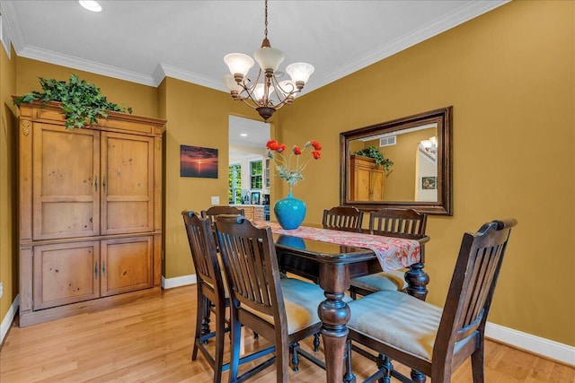 2082 Blackberry Ln, Howell, MI 48855 - dining area with light wood-style floors, a chandelier, baseboards, and crown molding
