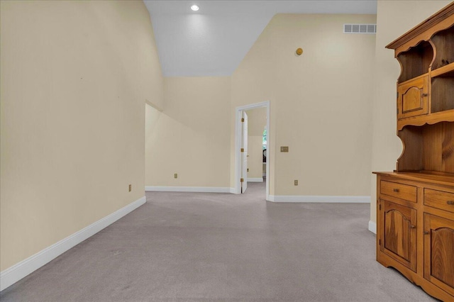 2082 Blackberry Ln, Howell, MI 48855 - unfurnished room with light colored carpet, high vaulted ceiling, baseboards, and recessed lighting