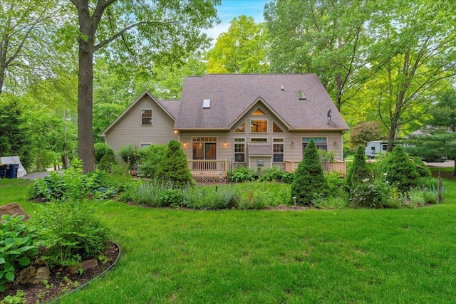 2082 Blackberry Ln, Howell, MI 48855 - back of property featuring a yard, a wooden deck, and a shingled roof