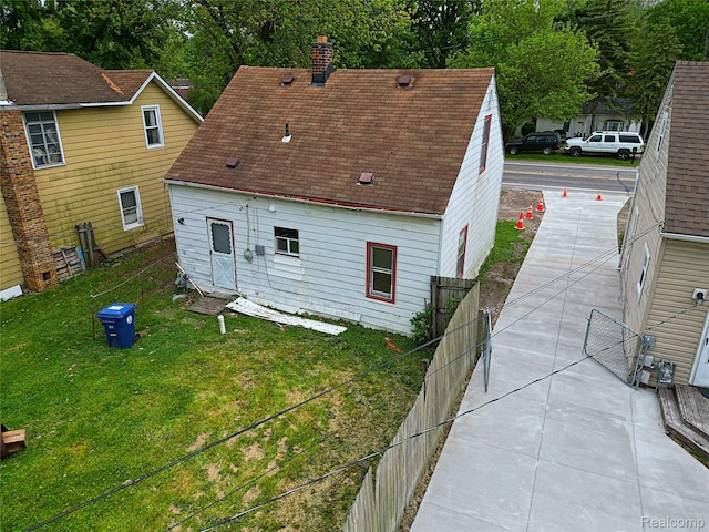 19444 Inkster Rd, Redford, MI 48240 - rear view of house featuring a chimney and roof with shingles