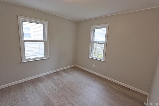 19444 Inkster Rd, Redford, MI 48240 - unfurnished room with plenty of natural light, light wood-type flooring, baseboards, and crown molding