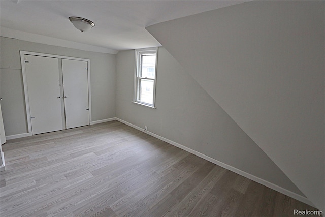 19444 Inkster Rd, Redford, MI 48240 - bonus room featuring light wood-style floors, vaulted ceiling, and baseboards
